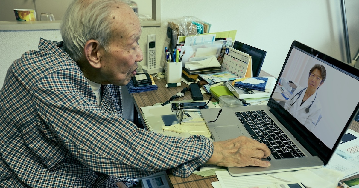 
  Senior adult consulting with healthcare professional via laptop computer
