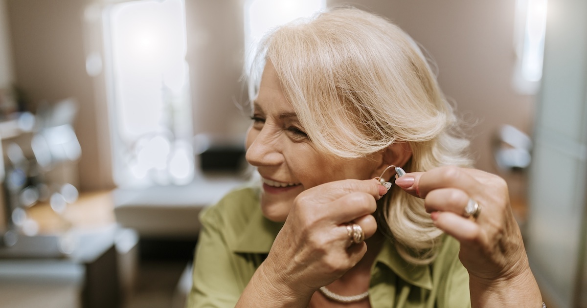 
  Person putting in a hearing aid
