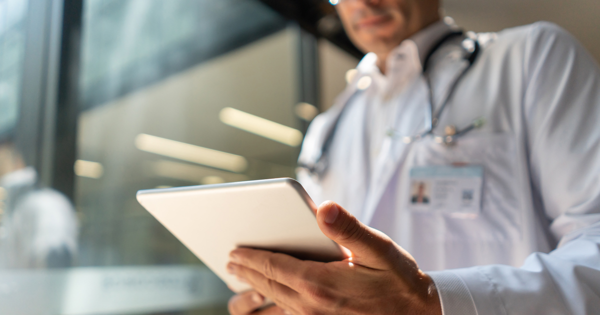 
  A doctor reviewing a patient's file on a digital tablet
