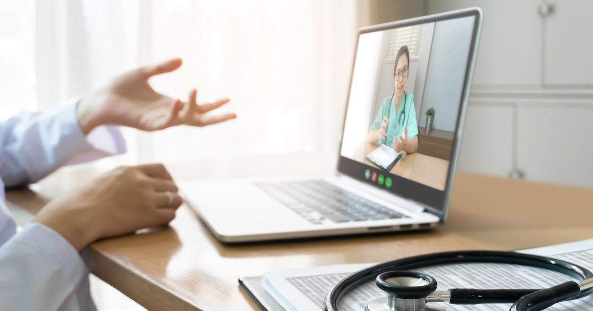 
  Healthcare provider on a computer talking to someone
