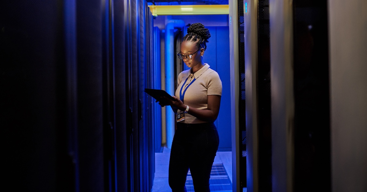
  Person standing in a data center
