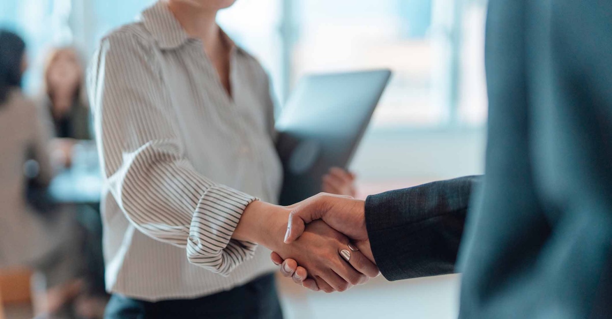 
  Two people shaking hands
