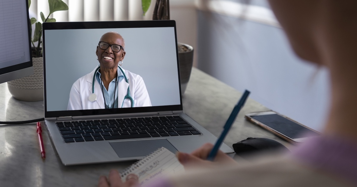 
  Physician interacting remotely with a person via laptop
