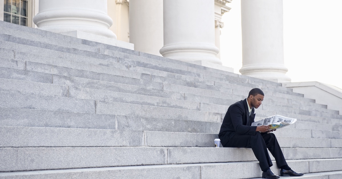 
  Man sitting on court building steps
