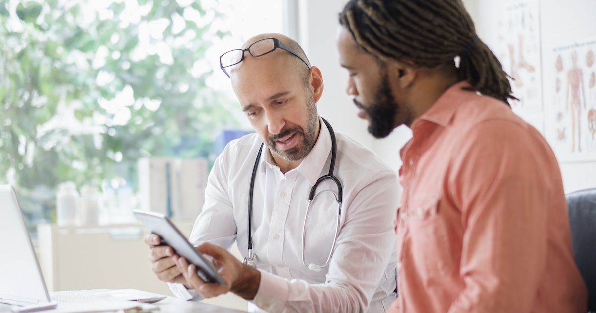 
  Health care professional consulting with patient 
