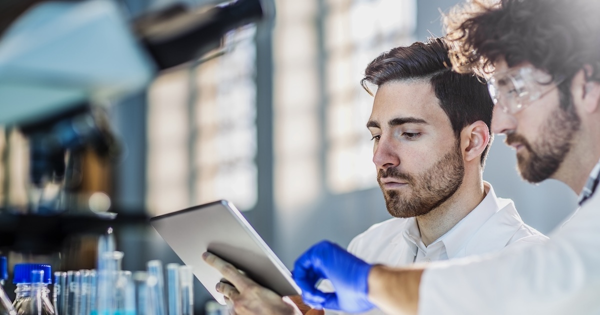 
  Two healthcare professionals looking at a tablet
