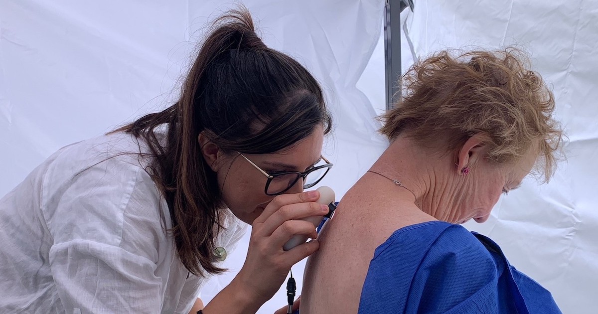 A doctor assessing a patient's skin