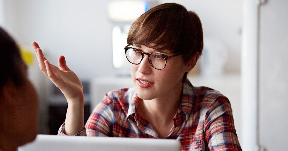 
  Person on a laptop speaking with someone and wearing glasses
