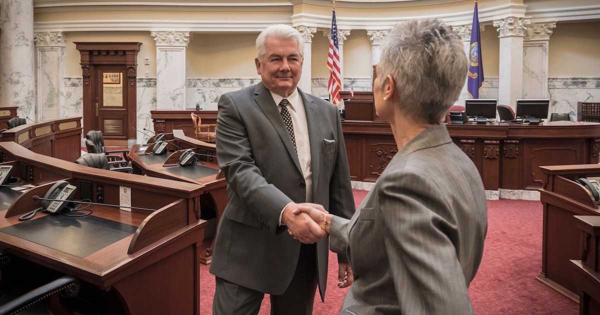 
  Two people shaking hands in a government building
