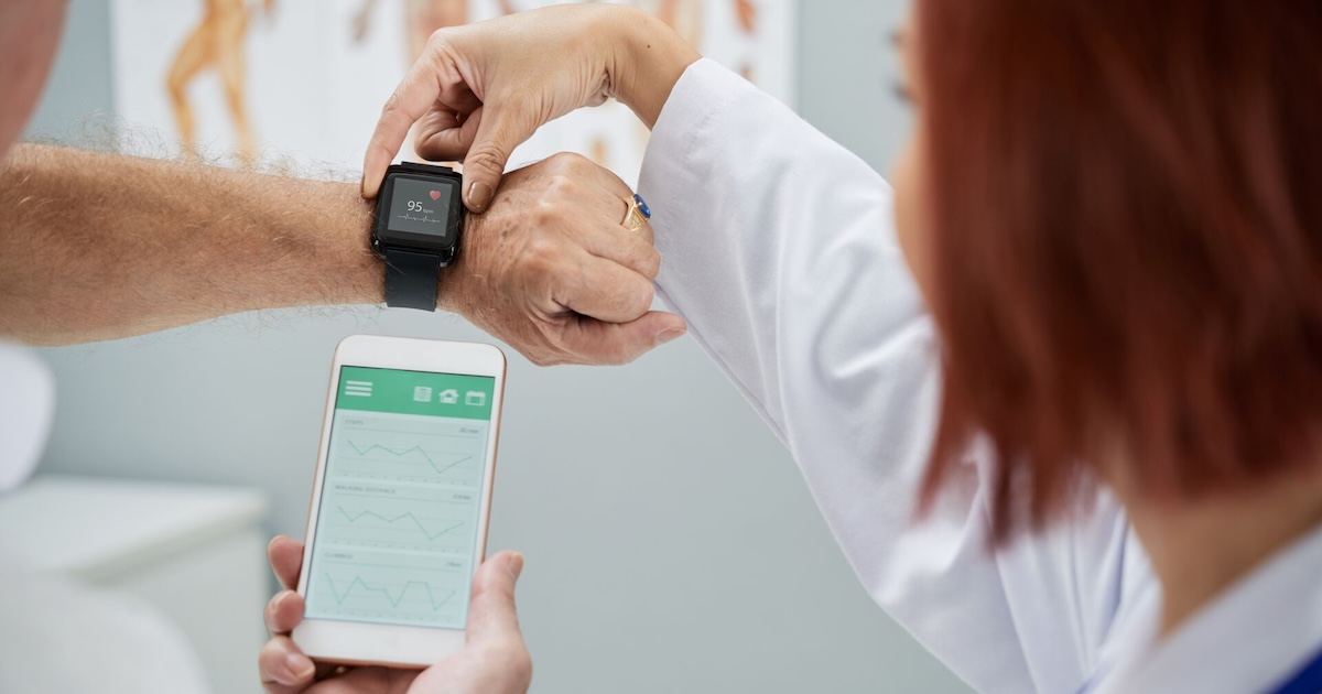 
  A doctor synchronising a patient's smartwatch with their mobile app

