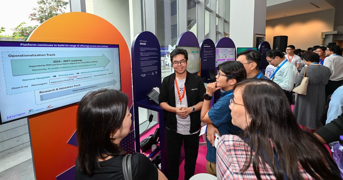 Attendees of Synapxe's first AI conference at a booth Attendees of Synapxe's first AI conference at a booth