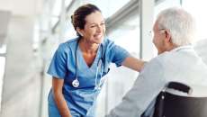 
  Person in a wheelchair next to a nurse
