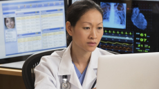 Healthcare technician reviewing MRI data