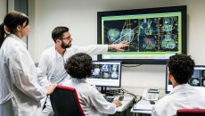 Four healthcare providers looking at a screen