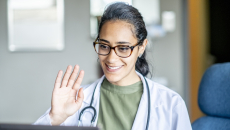 Healthcare professional engaging remotely via a laptop computer