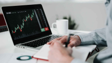 Young businessman using laptop for analyzing data stock market