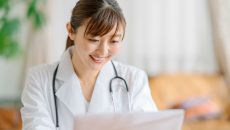 A doctor looking up a patient's data on a laptop computer