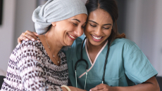 Healthcare provider sitting with a cancer care patient
