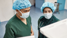 Two healthcare providers looking at computers