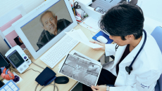 A doctor explaining a patient's heart X-ray findings via video call