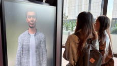 A pair of students interacting with an AI companion prototype