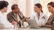 Doctors and businesspeople meeting in a room