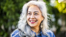 Portrait of a gray haired individual smiling