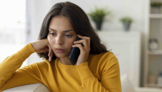 Person on the phone who looks concerned