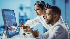 Two scientists sitting at a computer in a laboratory
