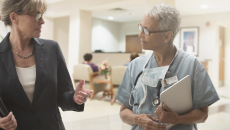 Two people in a clinical setting walking together