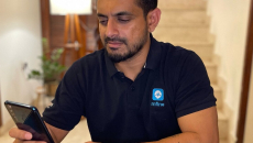 MFine CTO Ajit Narayanan holding a smartphone to measure his vitals