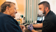 An Atrium Health community paramedic consults with patient in his home.