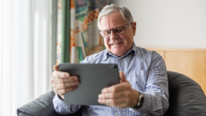 Senior patient looking at a tablet