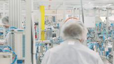 Workers in a Cue Health manufacturing facility