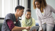 Healthcare worker consulting with a patient and family member