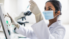 Scientist analyzing contents of test tube