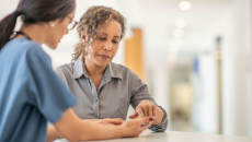 A healthcare provider and another person looking at something