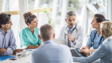 medical providers and business people sit around table