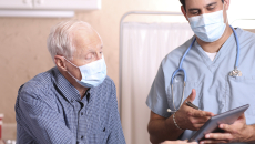 Healthcare provider and senior citizen on a tablet