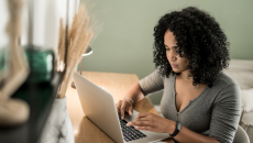 Person sitting down and looking at a computer