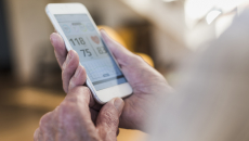 A close-up image of a person using a digital health app on a smartphone.