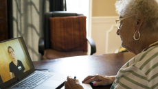 Patient consulting with healthcare practitioner via laptop computer