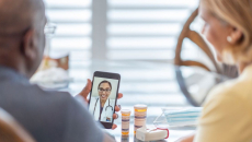 A man and a woman using a smartphone to talk to a provider