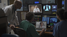 Healthcare professionals reviewing data on computer screens