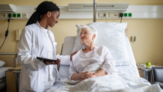 Healthcare professional consulting with a patient in the hospital