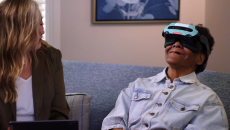 Patient using a Rendever headset while sitting next to another individual