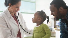 A parent with a toddler at a doctor's appointment