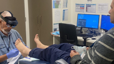 A clinician demonstrating the use of mixed-reality glasses for remote assessment of a foot wound