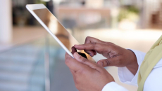 A close up of a person holding a tablet