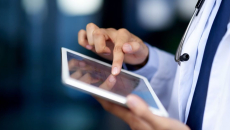 A close-up of a doctor using a tablet.